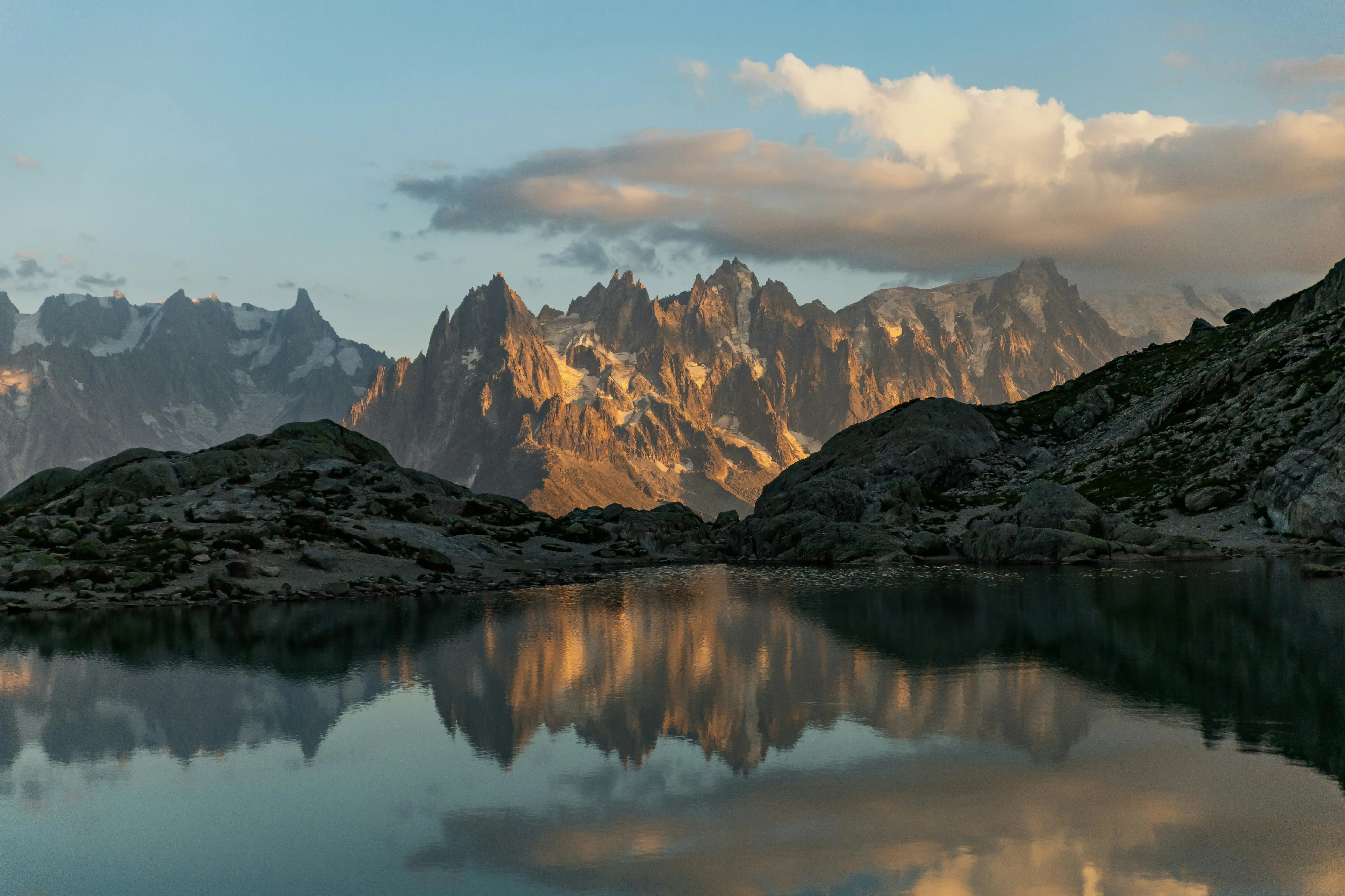 Travel to Chamonix - Tranquil lake leads to large valley with mountains in the background of Chamonix