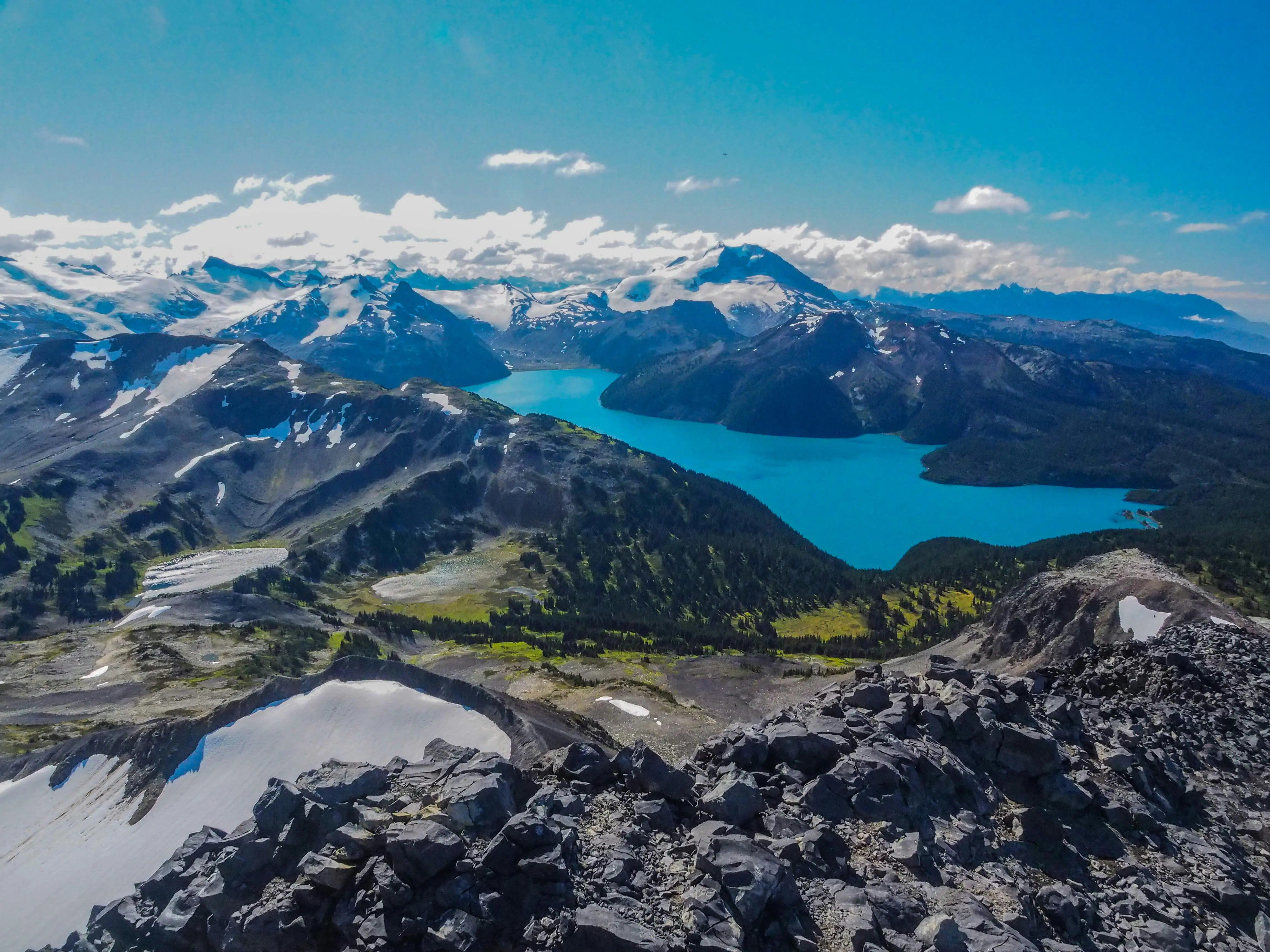 View of snow-capped mountain peaks in the ski resort of Whistler in Canada with blue sky in the background